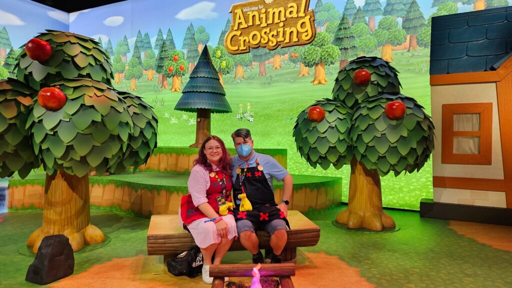 Sam and Steve sitting by a campfire in the Animal Crossing Exhibit at Nintendo Live 2023
